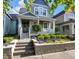 Charming exterior view of a two-story home with a welcoming front porch and landscaped garden at 1322 Marlowe Ave, Indianapolis, IN 46202