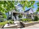 Charming exterior view of a two-story home with a welcoming front porch and landscaped garden at 1322 Marlowe Ave, Indianapolis, IN 46202