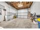 Spacious garage with white walls, concrete floors, and a large white garage door at 1322 Marlowe Ave, Indianapolis, IN 46202