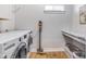 Well-lit laundry room with modern appliances, a marble countertop, and ample storage space at 1322 Marlowe Ave, Indianapolis, IN 46202