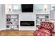 Living room with a fireplace, built-in bookshelves and an accent chair at 1322 Marlowe Ave, Indianapolis, IN 46202
