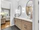 Contemporary main bathroom with dual sinks, neutral cabinetry, and modern fixtures with a bedroom view at 1322 Marlowe Ave, Indianapolis, IN 46202