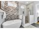 Luxurious main bathroom featuring a freestanding tub, glass-enclosed shower, and designer tile accents at 1322 Marlowe Ave, Indianapolis, IN 46202