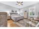 Spacious main bedroom with hardwood floors, natural light, neutral decor, and stylish furnishings at 1322 Marlowe Ave, Indianapolis, IN 46202