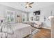 Bright and airy main bedroom featuring hardwood floors, shuttered windows, and cozy seating area at 1322 Marlowe Ave, Indianapolis, IN 46202