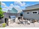 Backyard featuring outdoor kitchen with grill, modern patio furniture, and well-kept landscaping at 1322 Marlowe Ave, Indianapolis, IN 46202