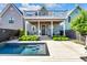 Backyard featuring covered porch, modern pool with integrated steps, and manicured landscaping at 1322 Marlowe Ave, Indianapolis, IN 46202