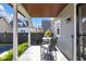 Back porch with gray tile, seating, and view of landscaped backyard and pool at 1322 Marlowe Ave, Indianapolis, IN 46202