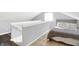 Well-lit attic bedroom space features a cozy bed and a view of the lower floor through a staircase at 1333 Spann Ave, Indianapolis, IN 46203