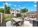 Landscaped backyard boasts an outdoor dining area, fire pit, and lush green lawn at 1333 Spann Ave, Indianapolis, IN 46203
