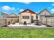 Lush backyard features a patio with fire pit, dining area, and cozy seating under string lights at 1333 Spann Ave, Indianapolis, IN 46203