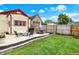 Well-maintained backyard featuring a patio with furniture, fire pit, and beautifully manicured lawn at 1333 Spann Ave, Indianapolis, IN 46203