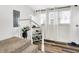 Inviting entryway features staircase, a decorative bar cart, ample light from windows, and hardwood floors at 1333 Spann Ave, Indianapolis, IN 46203