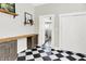 Hallway featuring checkered floors, built in cabinets, and view of staircase at 1333 Spann Ave, Indianapolis, IN 46203