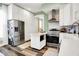 Spacious kitchen with stainless steel appliances, island, plenty of cabinets, and hardwood floors at 1333 Spann Ave, Indianapolis, IN 46203