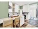 Charming kitchen featuring white cabinets, stainless appliances, hardwood floors, and an eat-in island at 1333 Spann Ave, Indianapolis, IN 46203