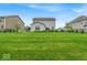 Spacious backyard featuring a well-maintained lawn, garden area, and privacy fence at 13495 Forest Glade Dr, Fishers, IN 46037