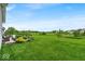 Lush backyard with a stone patio, comfortable seating, and serene views of the green landscape at 13495 Forest Glade Dr, Fishers, IN 46037