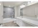This modern bathroom features double sinks, large mirror, and a shower/tub combo at 13495 Forest Glade Dr, Fishers, IN 46037