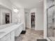This spacious bathroom features a double vanity, a glass shower, and a walk in closet at 13495 Forest Glade Dr, Fishers, IN 46037