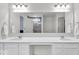 This well-lit bathroom boasts a large mirror and ample storage space at 13495 Forest Glade Dr, Fishers, IN 46037