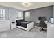 The carpeted bedroom offers neutral walls, two bedside tables, and a black bedspread at 13495 Forest Glade Dr, Fishers, IN 46037
