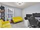 This bedroom features gray walls, a yellow sofa, a black desk, and carpeted floors at 13495 Forest Glade Dr, Fishers, IN 46037