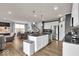 Open concept kitchen area with stainless steel appliances and seating near the stairs at 13495 Forest Glade Dr, Fishers, IN 46037
