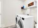 This laundry room has a washer, dryer, and shelving for storage at 13495 Forest Glade Dr, Fishers, IN 46037