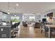 Open-concept living area showcases the kitchen island with counter seating, dining table and comfortable living space at 13495 Forest Glade Dr, Fishers, IN 46037