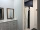 Well-lit bathroom with double vanity, tile floors, and shower at 1518 S Talbott St, Indianapolis, IN 46225