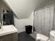 Bathroom features a single sink, toilet and a shower with a shower curtain at 1518 S Talbott St, Indianapolis, IN 46225