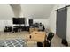 A modern bonus room featuring a desk area, tv and a comfortable seating area with a gray accent rug at 1518 S Talbott St, Indianapolis, IN 46225