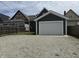 A modern detached garage with vinyl siding and white doors providing convenient parking at 1518 S Talbott St, Indianapolis, IN 46225