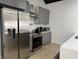 Modern kitchen featuring stainless steel appliances, gray cabinetry, and an open layout with white countertops at 1518 S Talbott St, Indianapolis, IN 46225