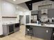 Open concept kitchen featuring modern gray cabinetry, stainless steel appliances, and stylish island seating at 1518 S Talbott St, Indianapolis, IN 46225