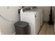 Bright laundry room with front load washer, dryer, and vinyl floor at 1518 S Talbott St, Indianapolis, IN 46225