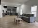 Open living area featuring wood floors, natural light, a gray sectional couch and an eat-in kitchen at 1518 S Talbott St, Indianapolis, IN 46225