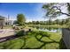Lush backyard with a pond view, a deck with outdoor seating, and mature trees providing shade and privacy at 15388 Follow Dr, Noblesville, IN 46060