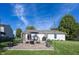 Spacious backyard with a stone patio, dining set, and fire pit, ideal for outdoor entertaining and relaxation at 15388 Follow Dr, Noblesville, IN 46060