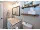 Well-lit bathroom with framed mirror, wood shelves, and neutral color palette at 15388 Follow Dr, Noblesville, IN 46060