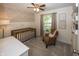 Charming Bedroom with decorative wallpaper, a brown crib, and cozy seating at 15388 Follow Dr, Noblesville, IN 46060
