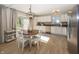 Cozy dining area with a modern light fixture, hardwood floors, and access to the backyard at 15388 Follow Dr, Noblesville, IN 46060