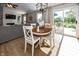 Open dining area connected to living room with modern lighting and outdoor views at 15388 Follow Dr, Noblesville, IN 46060