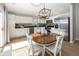 Bright kitchen features stainless steel appliances, a wooden table, and sleek white cabinetry at 15388 Follow Dr, Noblesville, IN 46060