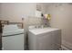 Bright laundry room featuring a white washer and dryer set and black and white patterned tile floors at 15388 Follow Dr, Noblesville, IN 46060