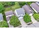 Aerial view showcases home with lush trees, driveway, and adjacent neighborhood at 15411 Wandering Way, Noblesville, IN 46060