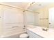 Bright bathroom featuring a tub-shower combo, white vanity, and a large mirror at 15411 Wandering Way, Noblesville, IN 46060