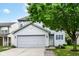 Traditional two-story home with a gray garage door and light-blue shutters at 15411 Wandering Way, Noblesville, IN 46060