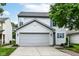 Charming two-story home features a gray garage door and light-blue shutters at 15411 Wandering Way, Noblesville, IN 46060